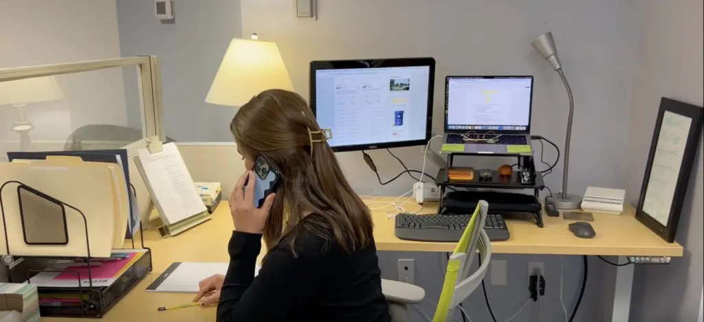 An MCEDV advocate at her desk answering a call on the helpline