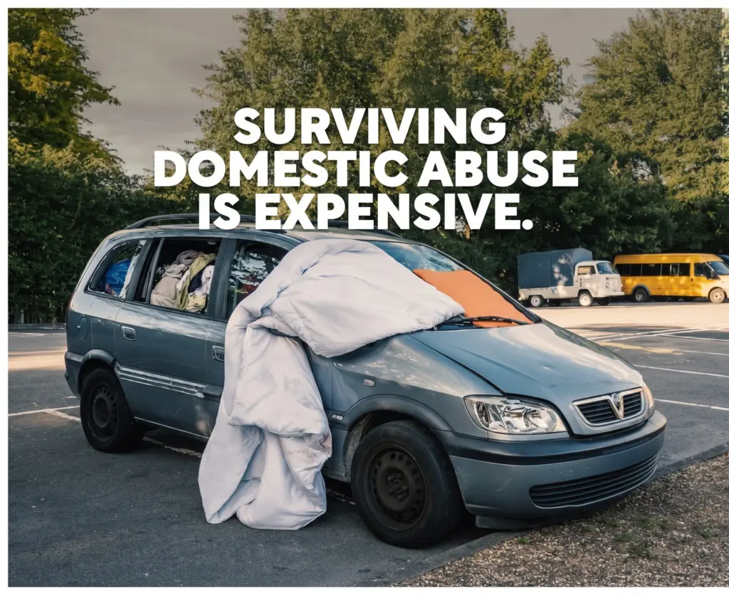 Surviving domestic abuse is expensive: a minivan packed with belongings and a blanket over the windshield